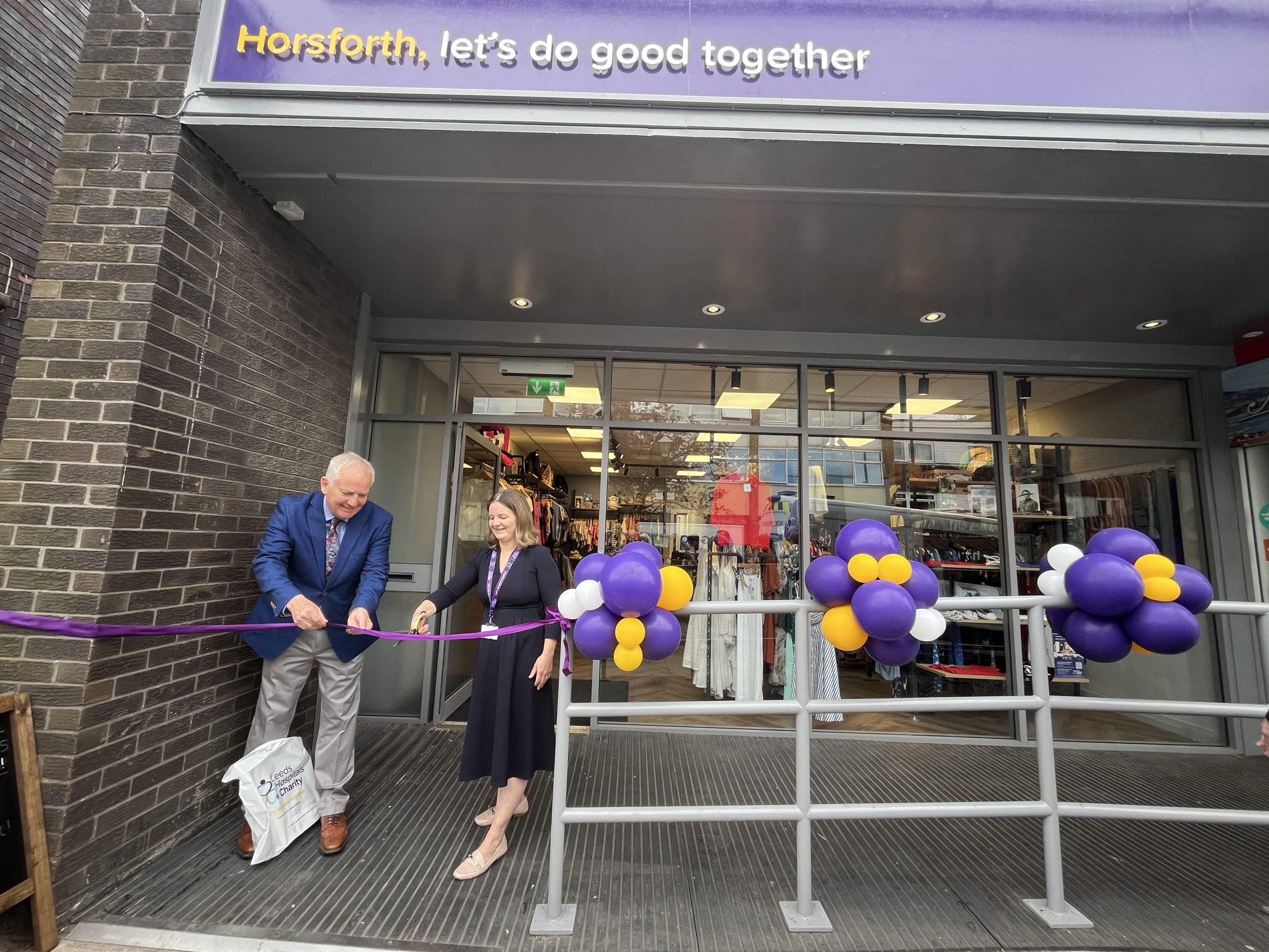 Charity Trustee, Mark Davies with Esther Wakeman, CEO cutting the ribbon outside the Horsforth charity shop